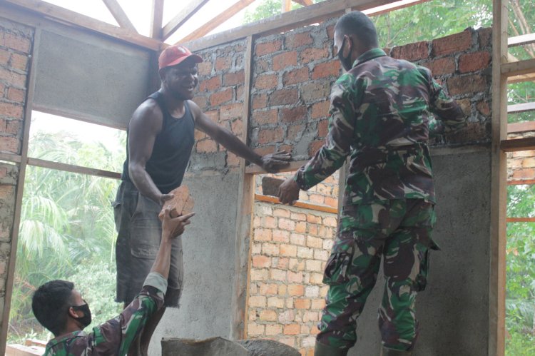 Satgas Yonof awang long saat membantu warga Bupaul membangun rumah