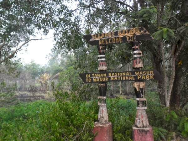 Ilustrasi Papan Nama Pintu Masuk Taman Nasional Wasur